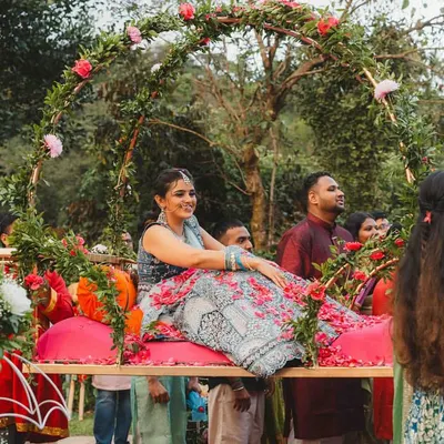 A truly royal entry for our bride, Supreetha. She had always dreamed of a grand entrance, so we designed this beautiful floral palanquin (doli) for her to be carried in like a princess for her Haldi ceremony.