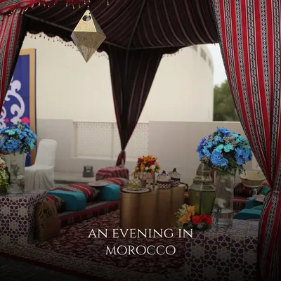 For an international wedding in Bahrain, I created an "Evening in Morocco" theme. This photo shows a traditional tented seating area with low cushions, ornate rugs, and hanging lanterns, instantly transporting guests.