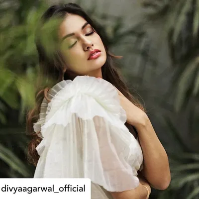 The stunning Divya Agarwal wears our white crop top with a dramatic, single-sided organza ruffle sleeve. This piece is part of our collaboration with Bohoraani and showcases our love for modern, architectural details.