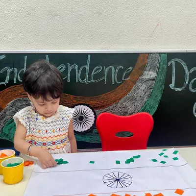 A little patriot carefully creates the Indian flag using pieces of colored paper. This Independence Day activity helps foster a sense of national pride while developing fine motor skills.