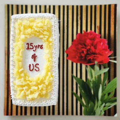 A lovely and fresh pineapple cake I made to celebrate a 15-year anniversary. The message "15yrs of US" is piped in the center, surrounded by chunks of sweet pineapple.