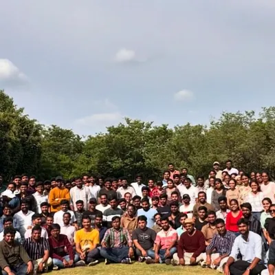 A huge group of happy adventurers posing for a photo on a grassy clearing during one of our weekend events. This is what our community looks like, full of energy and ready for fun.