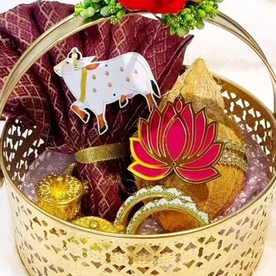 My signature gold metal basket, shown here filled with a complete set of traditional items for a wedding. The intricate design of the basket itself becomes a memorable part of the gift.