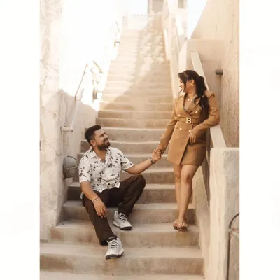 A romantic moment on a rustic staircase in Old Dubai. The warm, earthy tones and historic architecture provide a beautiful and unique backdrop for a pre-wedding shoot.