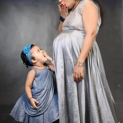 A precious moment between a mother and her daughter. I created this matching set with a silver maternity gown for the mom and a cute grey frock for the little one.