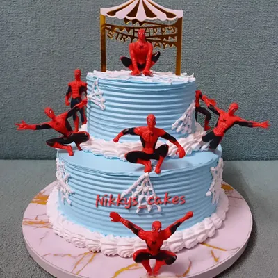 This two-tier Spider-Man cake is perfect for a young superhero fan. It features multiple Spider-Man figurines in action poses, climbing up the blue web-textured tiers, ready for a birthday adventure.
