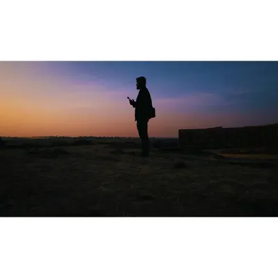 Me, the drone pilot, silhouetted against a beautiful sunset sky. This is where I feel most at home, out in the open with my drone.