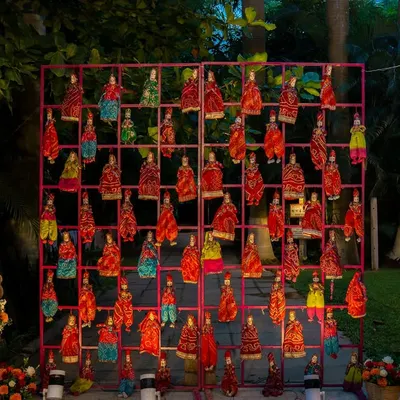 A unique and artistic decor element featuring a grid of colorful puppets, adding a touch of traditional Rajasthani craft to the wedding decor.