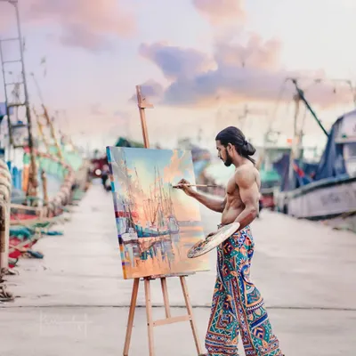 Me painting a seascape live at the Malpe harbor. Working outdoors allows me to directly capture the light and atmosphere of the scene, translating the real-life view onto the canvas.