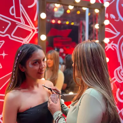 My pop-up glitter station at an event. You can see the vanity mirror with lights, which creates the perfect setup for getting guests glammed up.