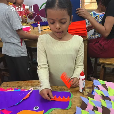 We traveled to China in our "Art Around the World" summer camp! This student is working on a colorful paper dragon, a symbol of power and good luck in Chinese tradition.