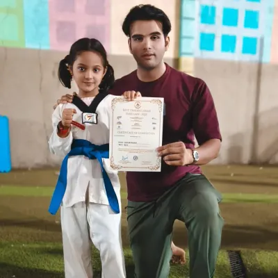 A proud moment with one of my young champions, Zainab Shaikh, as she receives her blue belt certificate. Her hard work and dedication have paid off.