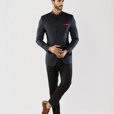 A full-length view of our bespoke navy Jodhpuri suit. The sharp, clean silhouette and mandarin collar offer a powerful and elegant statement for any formal occasion.