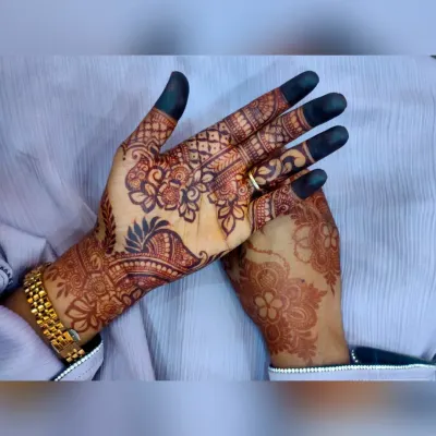A classic party henna design with floral patterns and filled fingertips. This is a popular choice for festivals and celebrations.