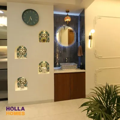 This wash basin area features a Persian theme with a beautiful printed basin, a Turkish-style lamp, and decorative niches with patterned tiles, creating a rich and exotic look.