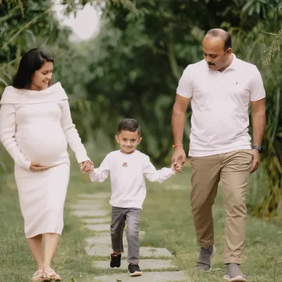 A family strolls together, hand in hand, on the cusp of welcoming a new member. I focus on capturing these natural interactions, showing the bond between parents and the excitement of an older sibling, making for an honest family maternity portrait.