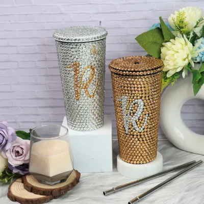 Ready to shine? My personalized bling tumblers are perfect for adding sparkle to every sip. This image shows the silver and gold options, both customizable with a rhinestone initial.