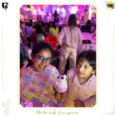 Our mocktail bar is a hit with the little VIPs. Here, two young guests enjoy a fun, whipped-cream-topped drink designed just for them.