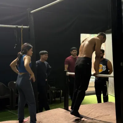 A coach spotting a member during dips. This hands-on guidance ensures proper form and safety, allowing the athlete to push his limits.