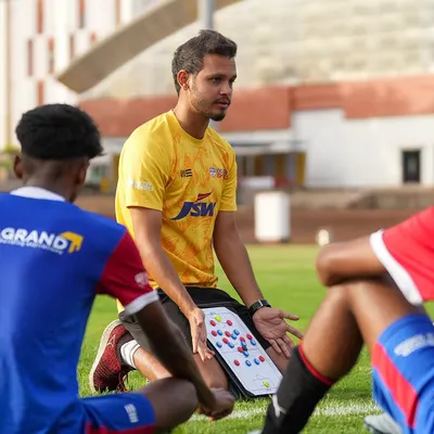 A coach uses a tactics board to explain formations and player movement to our U19 squad. We believe in developing intelligent players who understand the 'why' behind every drill and strategy.