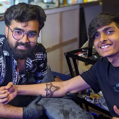 Sharing a proud moment with a client after finishing his custom geometric eagle tattoo. Seeing the satisfaction on a client's face is the best part of my job.