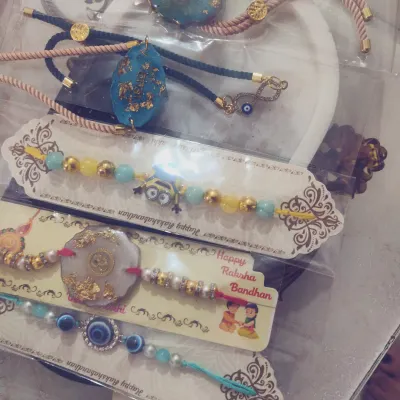A selection of my custom resin rakhis, perfect for Raksha Bandhan. These are designed to be keepsakes, with options like gold-flecked resin and beaded evil eye bracelets.