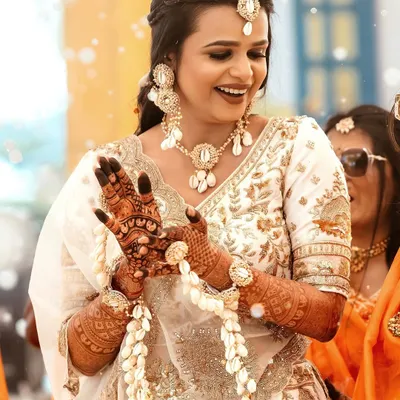 A happy bride during her Haldi ceremony, adorned with beautiful seashell jewellery that I provided. The look is fresh, bright, and perfect for the occasion.