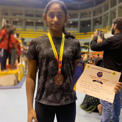 Celebrating Riya B's fantastic achievement. She secured the Bronze medal on the Uneven Bars at the State Dasara sports meet, a testament to her hard work and dedication.