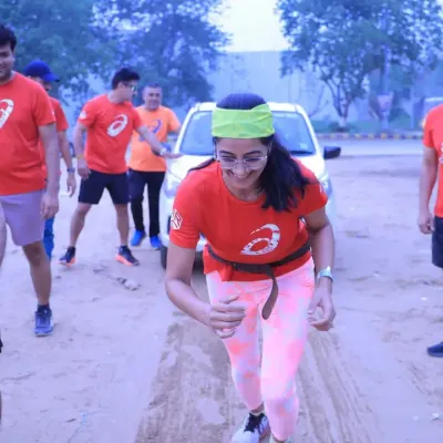A participant showing her strength by pulling a car during our Coach's Fitness Challenge. We push boundaries and redefine what's possible.