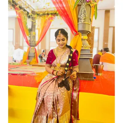 A stunning magenta velvet blouse with detailed embroidery on the sleeves. This blouse was paired with a traditional silk saree for a rich and royal wedding look.