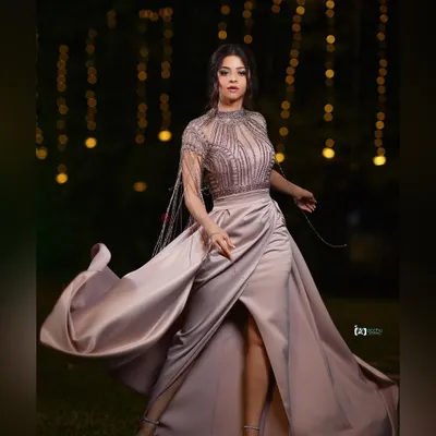 Capturing movement is key to a dynamic shot. The flowing fabric of this satin gown against the soft bokeh of the background lights creates a sense of drama and elegance for this red carpet look.