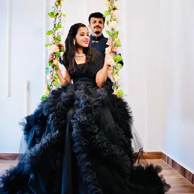 A stunning black ruffled gown perfect for a dramatic pre-wedding or couple's shoot. This dress makes a bold statement and looks incredible in my floral swing setup.