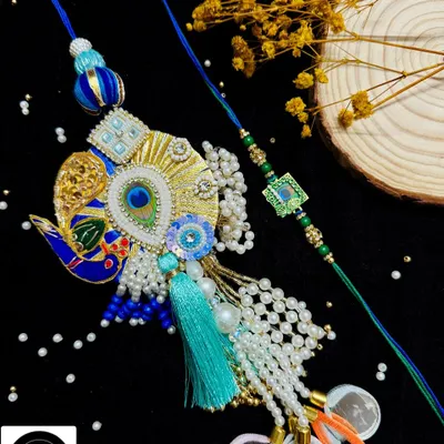 An exquisite peacock Lumba rakhi paired with a simpler, matching thread for your brother. The intricate beadwork and vibrant colors make this a standout piece for the festival.