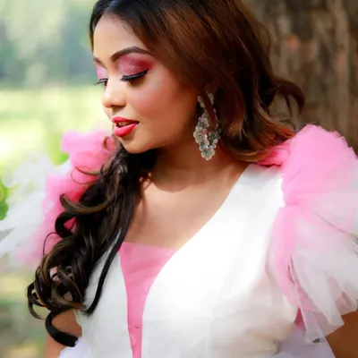 A close-up from the pink gown editorial shoot. The makeup features a bright pink eyeshadow with a sharp black wing, complementing the dress and creating a fresh, vibrant look.