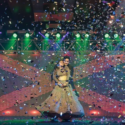 A magical moment under a shower of confetti. This shot captures the grand finale of the couple's Sangeet performance, full of romance and celebration.