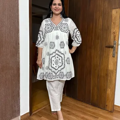 A look at one of my favorite accessories: statement earrings. This white embroidered peplum top and pant set is the perfect canvas for these beautiful silver earrings.