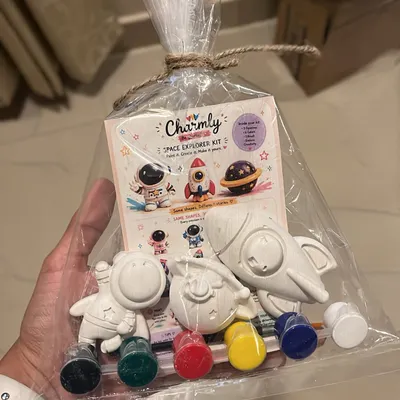 Your complete DIY kit comes packaged like this, making it a perfect creative art activity box or a gift. This example shows the Space Explorer kit with its figurines, paints, and brushes all included.