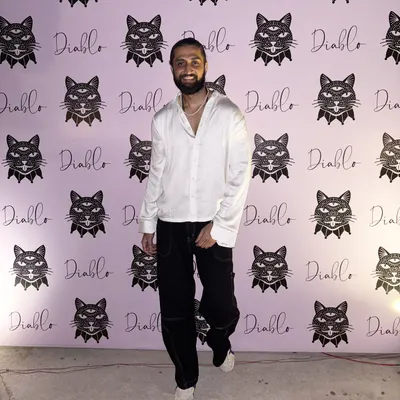 A full front view of a custom-made white party shirt. The relaxed fit and open collar give it a modern, stylish feel, perfect for a night out.