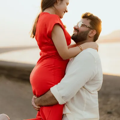 A joyful lift against the golden light of sunset at Aamby Valley. This image is full of warmth, happiness, and the beautiful glow of love.