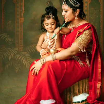 A beautiful themed portrait of a mother and her child dressed as Yashoda and Krishna. The intricate details and rich colors make this a stunning piece of art.
