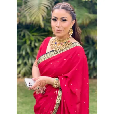Styling the gorgeous mother of the bride in a classic red saree with an elegant braided half-updo.
