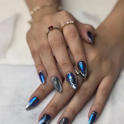 This is my signature chrome and cat eye combination. The technique involves layering a magnetic polish with chrome powder to get this incredible depth. The sharp almond shape of the extensions makes the design even more striking.