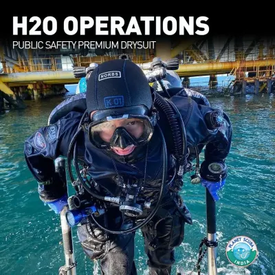 A public safety diver emerges from the water wearing the DUI H2O Operations drysuit. The suit is designed for contaminated water diving, with reinforced Kevlar panels and replaceable zip-seals to ensure the diver remains protected and the gear has minimal downtime.