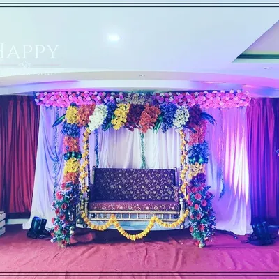 A beautifully decorated swing (jhula) for a baby shower or 'Sreemantham' ceremony. The swing is adorned with multi-colored flowers, creating a joyful and picturesque spot for the mother-to-be.