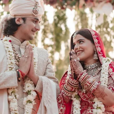 A beautiful moment from the wedding ceremony, where the bride and groom's henna-adorned hands come together in prayer.
