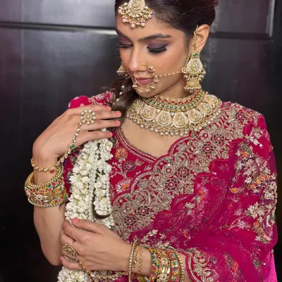 A classic North Indian bridal look featuring a dramatic smokey eye and bold jewelry. I focus on creating sharp, defined features that photograph beautifully while ensuring the skin looks radiant, not heavy.
