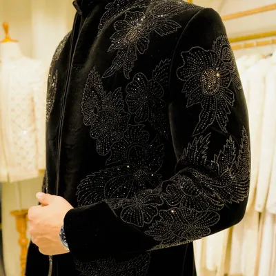 A close-up of the black-on-black floral embroidery on a velvet bandhgala. The intricate beadwork and thread create a subtle, luxurious texture that defines our craftsmanship.