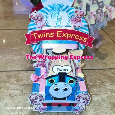 The 'Twins Express' train engine, designed for a baby boy and girl. I use both blue and pink colors and cute twin-themed cutouts to make it special.