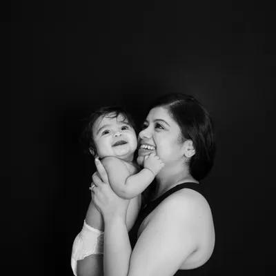 A classic black and white portrait of a mother and her baby. Stripping away the color lets the pure emotion and connection shine through, creating a truly timeless piece of art for your family.