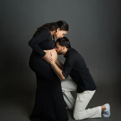 A classic and tender pose that I love to capture. The dad-to-be kneeling to kiss the baby bump is a powerful symbol of love and anticipation for their new arrival.